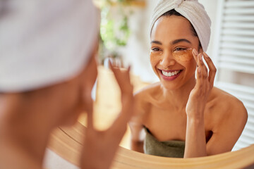 Poster - Woman applying eye mask on dark circles