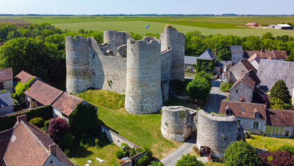 Wall Mural - Aerial view of the medieval castle of Yèvre le Châtel in the French department of Loiret - Enclosure with 4 round towers at the top of a hill in a rural village