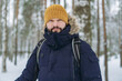 © Yulia Raneva - winter portrait of bearded caucasian man in knit hat and warm insulated jacket in snowy park
