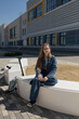 © ADDICTIVE STOCK - Teen girl resting on white bench in city