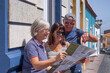 © luciano - Happy group of traveler senior people looking at city map during a leisure trip in La Palma, Canary islands, enjoying a sunny day and healthy lifestyle
