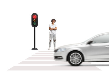 Wall Mural - Young afro american man with dreadlocks standing and waiting at traffic lights