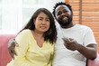 © amorn - Happy young Asian woman and African American male spending time together at home