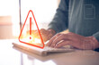 internet network security concept, man typing on keyboard with triangle warning sign developer with triangle caution warning sign for notification error and maintenance, e-document data protection