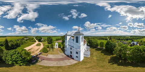 Wall Mural - full hdri 360 panorama aerial view on red brick neo gothic catholic church in countryside or village in equirectangular projection with zenith and nadir. VR  AR content