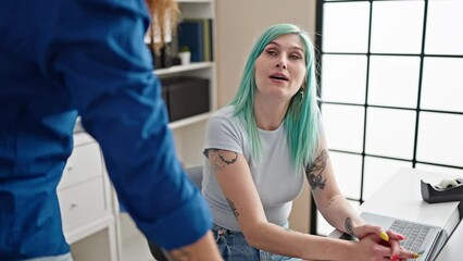 Poster - Man and woman business workers using laptop speaking at office