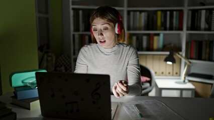 Sticker - Young blonde woman student having video call writing notes at library university