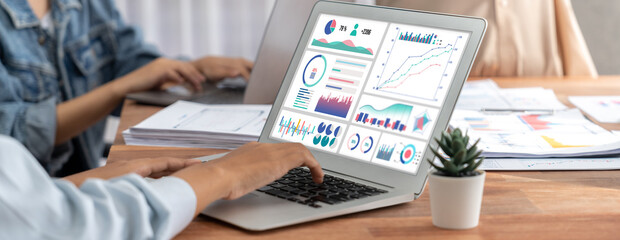 Leinwandbilder - Panorama shot analyst team utilizing BI Fintech to analyze financial report with laptop. Businesspeople analyzing BI power dashboard displayed on laptop screen for business insight. Scrutinize