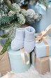 Blue booties among the gifts under the Christmas tree. Waiting for the birth of a child at Christmas.	
