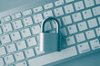 © pla2na - Flat lay padlock on computer keyboard background in monochrome tone. Encryption username password in online internet website, cyber security, privacy data information protection, firewall concept.