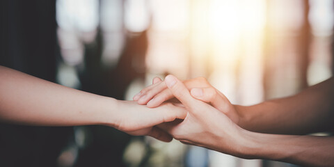 husband and wife join hands to cheer ,relationship care concept ,comforting family members ,mutual e
