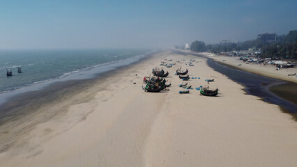 drone shot of lined up traditional bangladeshi wooden handcrafted fishing boats called sampan at cox