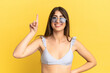 © luismolinero - Young caucasian woman in swimsuit in summer holidays isolated on yellow background pointing up a great idea