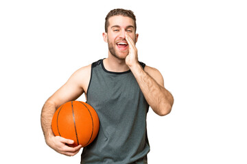 Wall Mural - Handsome young man playing basketball over isolated chroma key background shouting with mouth wide open