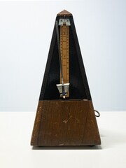 Antique metronome that produces an audible click at a regular interval 