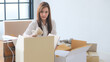 © themorningglory - Entrepreneur woman use laptop contact with customer and package product prepare shipping