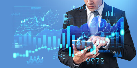 Poster - Man using tablet computer with financial diagrams