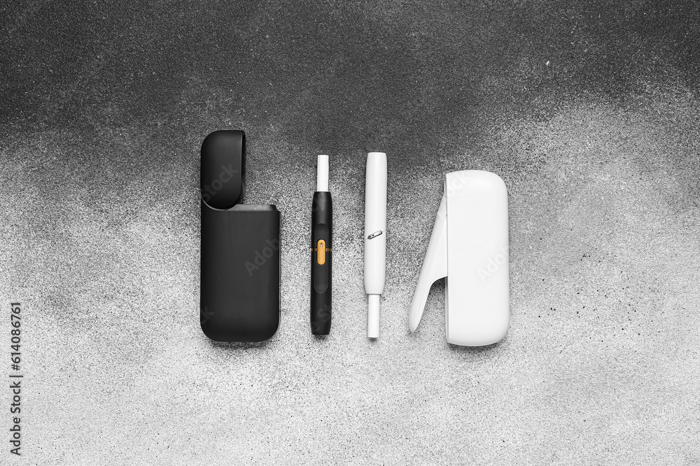 Different electronic cigars on grunge background