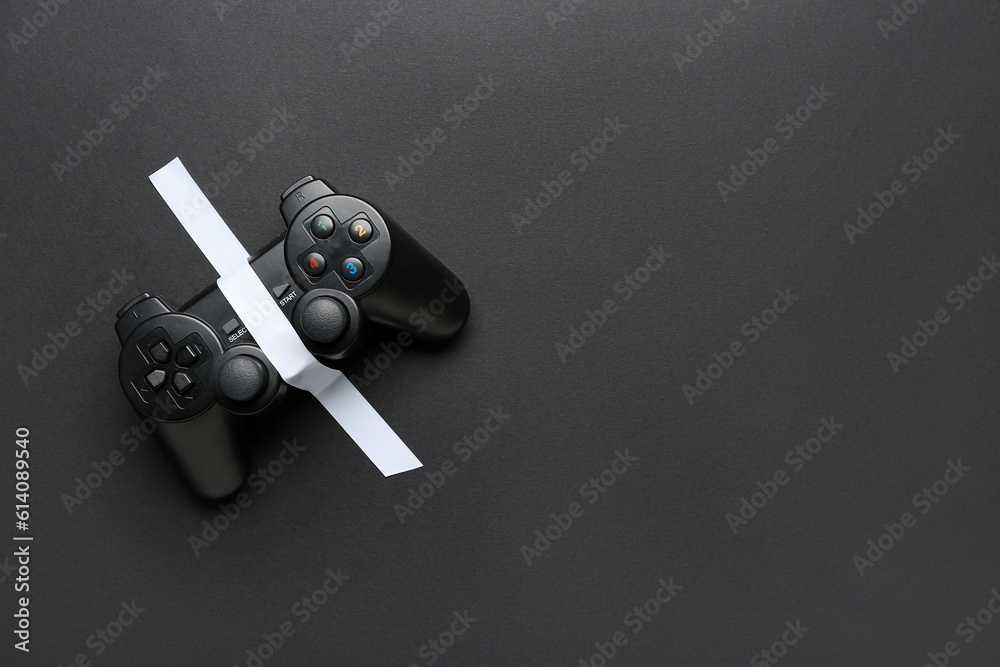 Game pad with adhesive tape on black background
