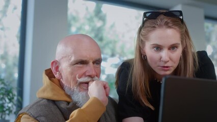 Stylish grandpa works in a cafe with a laptop. Oldman freelancer does networking with a colleague of a young girl in a cafe or restaurant. Remote work on an IT project. Esg Chat GPT, Global Growth