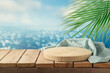 © maglara - Empty wooden podium with tablecloth on table over tropical beach bokeh background.  Summer mock up for design and product display