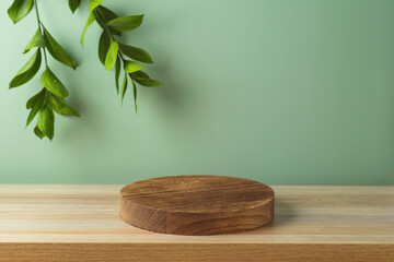 Empty wooden podium log on table over green wall with  leaves background.  Mock up for design and product display