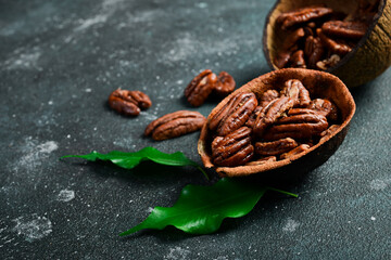 Wall Mural - Pecan. Caramelized walnut in a bowl. Side view. On a dark background.