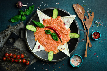 Wall Mural - Yumurta with tomatoes. Menemen Turkish breakfast food egg, tomatoes and pepper in pan. Close up. On a dark background.
