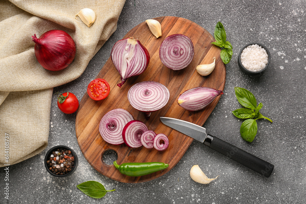 Board with fresh onion, tomatoes and spices on grey background