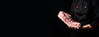 The chef holds a piece of pork belly meat in his hands. On a black background.