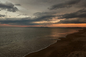 Wall Mural - Tourists enjoy the sunset at Platja de La Rubina in Empuriabrava. Girona. Catalonia. Spain