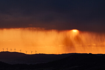 Wall Mural - The rain falls on the sunset in the Llaberia Nature Reserve. Tarragona. Catalonia. Spain