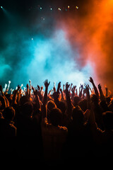 Crowd silhouettes cheering during a music concert