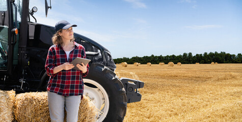 Sticker - Woman farmer with a digital tablet next to agricultural tractor