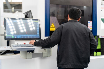 Leinwandbilder - Worker controls automatic machine tool in smart factory.