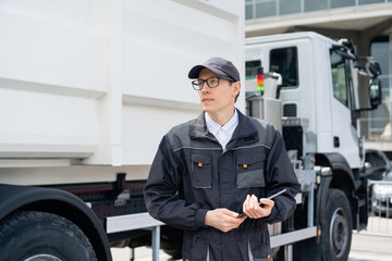 Poster - Manager with a digital tablet next to garbage truck..