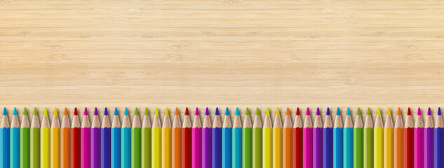 Wall Mural - Colored pencil group isolated on wooden background. Panoramic banner background