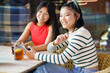 © javiindy - Two young Chinese women having a drink on the terrace of a typical bar in Granada.