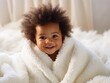 a very cute little black african baby kid with afro hair wrapped in soft white blanket on a bed smiling. image perfect for ads. big beautiful eyes and tiny nose. Generative AI