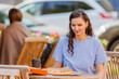 Attrative woman open pizza box and eating pizza outdoor cafe
