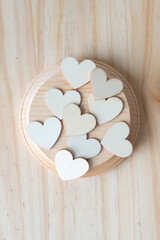 Canvas Print - machine-cut round wooden shape with wooden hearts on wood