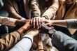© Jasmina - Diverse team of businesspeople joining their hands together in unity, coming together in success.