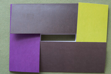 Wall Mural - folded scrapbook cards interlocked on rough green paper