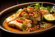 Thai dish of pla kapong neung manao, or steamed sea bass with lime sauce. The delicate sea bass is steamed is then bathed in a tangy lime sauce, with garlic, chili, and herbs. Generative Ai