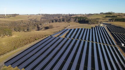 Wall Mural - aerial drone pullback reverse view of the hybrid gullen solar farm and gullen range wind farm for re