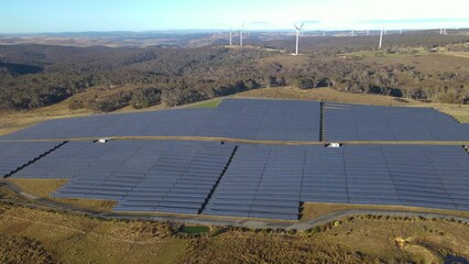 Wall Mural - aerial drone view of a hybrid wind and solar farm for renewable clean energy supply located at banni