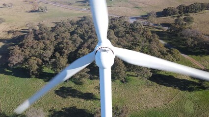 Wall Mural - aerial drone pullback reverse close up view of large wind turbines at a wind farm near bannister in 