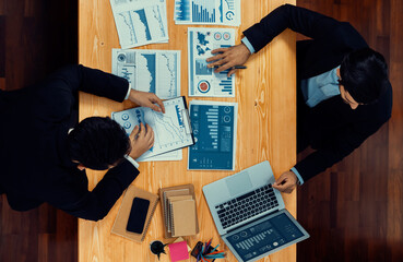 Poster - Top view analyst team discussing financial data on digital dashboard, analyzing chart and graph papers by data science software on wooden table background. Business intelligence and Fintech. Fervent
