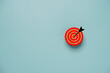 Red dartboard with arrow print screen on circle wooden block for setup business objective target concept.