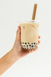 Woman holding a cup of bubble milk tea